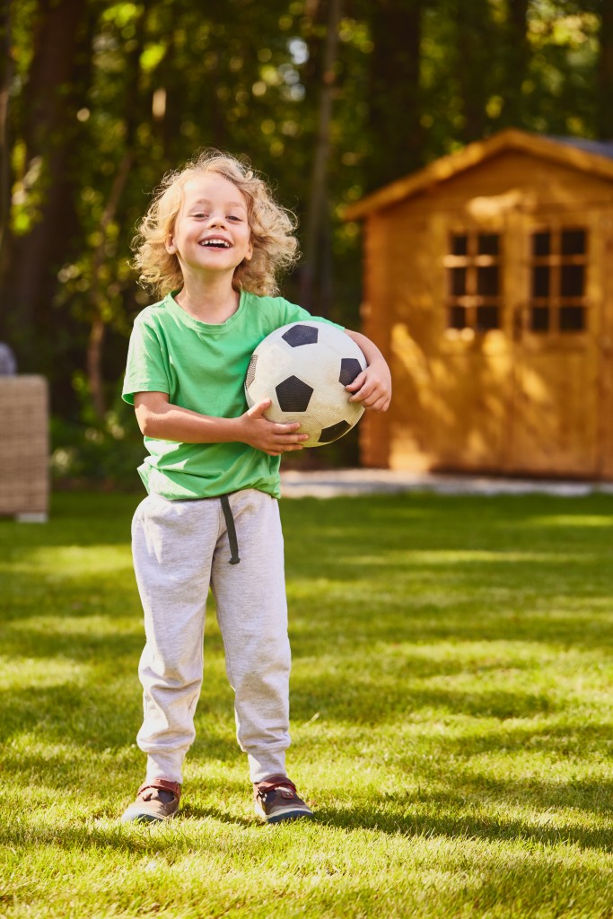 child holding a football