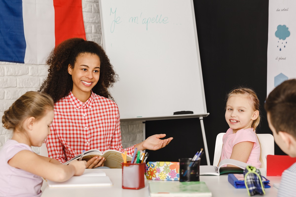 young school teacher teaching French to kids